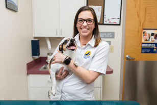 Veterinarian from Care First Animal Hospital holding a dog
